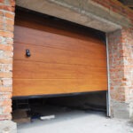 Installing garage door in new brick house construction. Installing garage door in new brick house construction.
