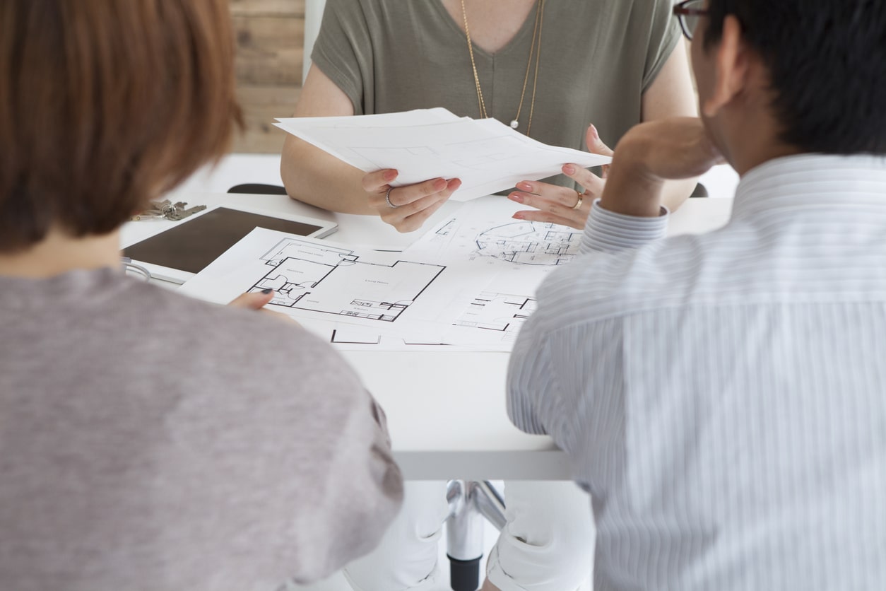 group going over building plans with homeowners in essex