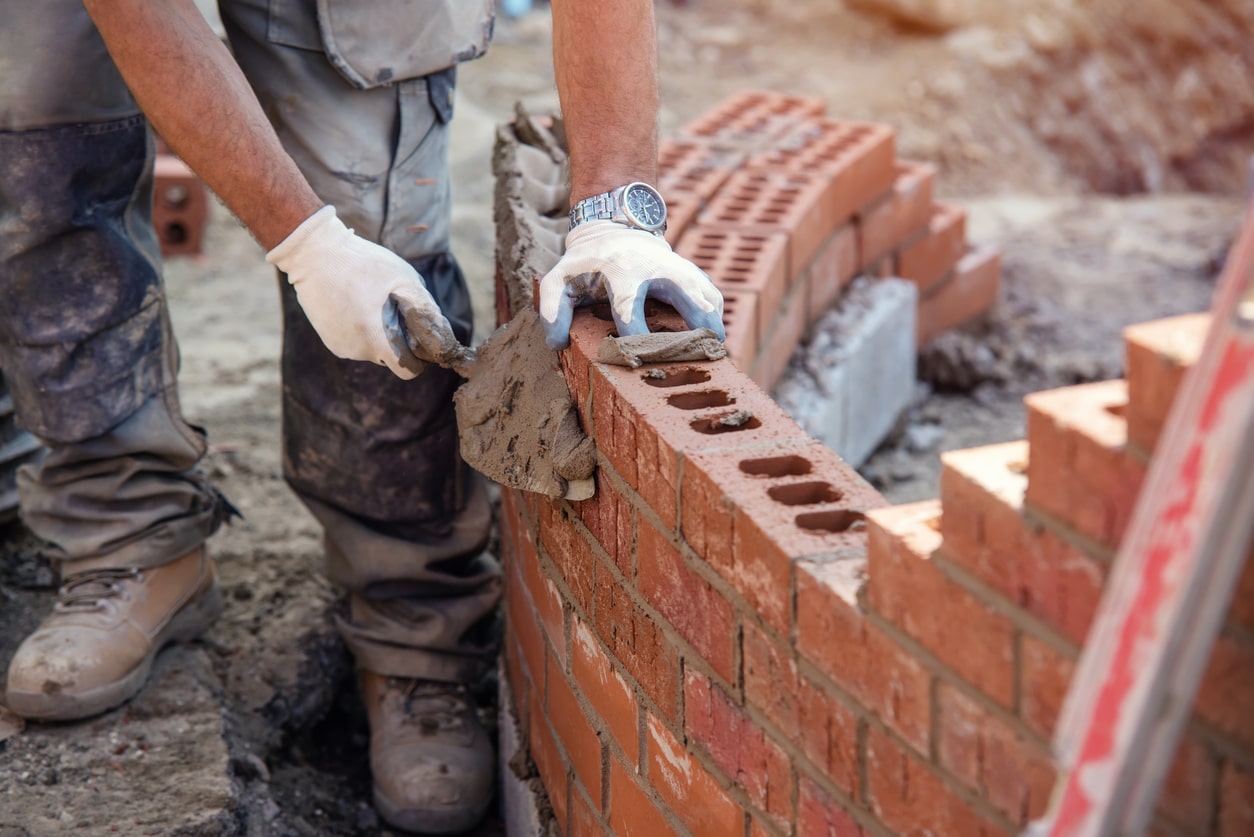 tradesman laying bricks for home extension in essex